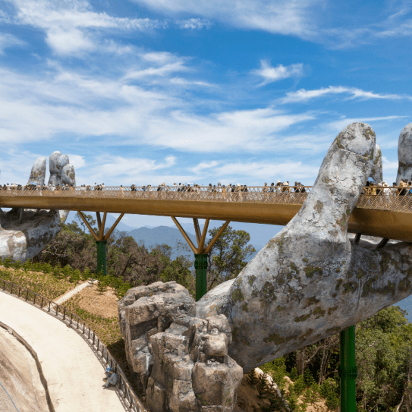 View of the Golden Hand Bridge at Ba Na Hills with scenic mountain backdrop.