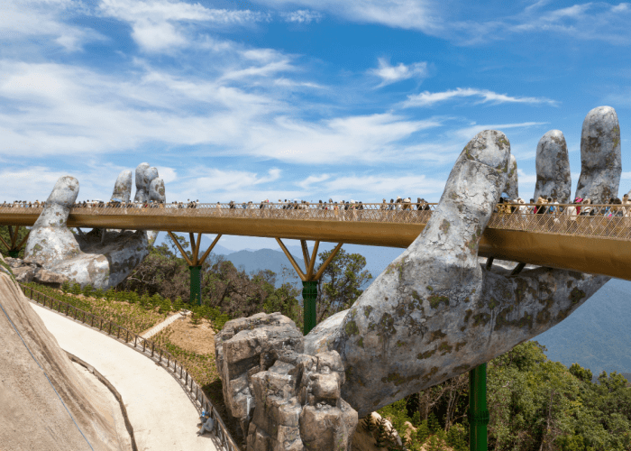 View of the Golden Hand Bridge at Ba Na Hills with scenic mountain backdrop.