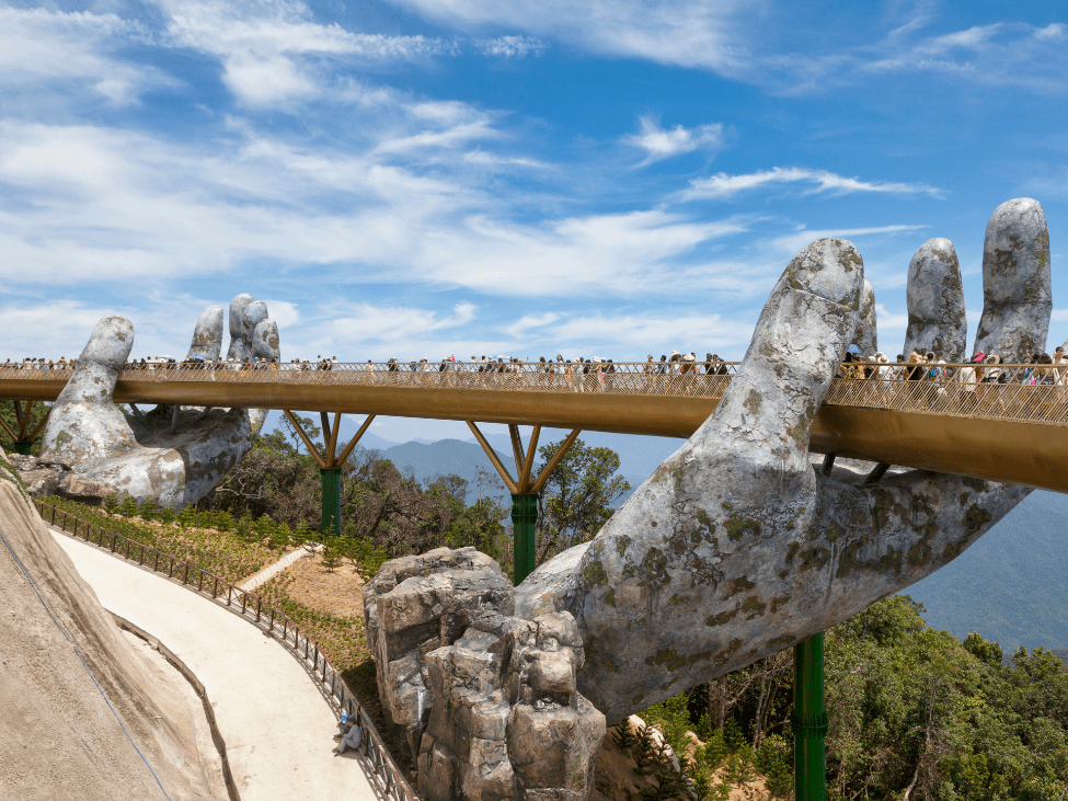 View of the Golden Hand Bridge at Ba Na Hills with scenic mountain backdrop.