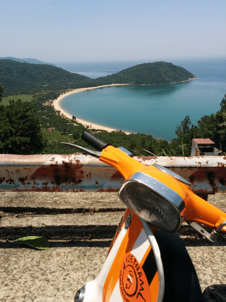 Scenic view of the Hai Van Pass coastal road during a Vespa tour.