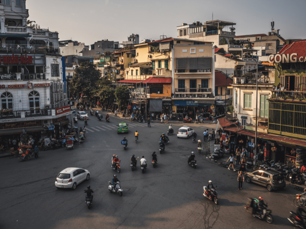 Bustling streets of Hanoi's Old Quarter filled with lanterns, toys, and mooncakes during the Mid-Autumn Festival, showcasing the vibrant decorations and festive items.