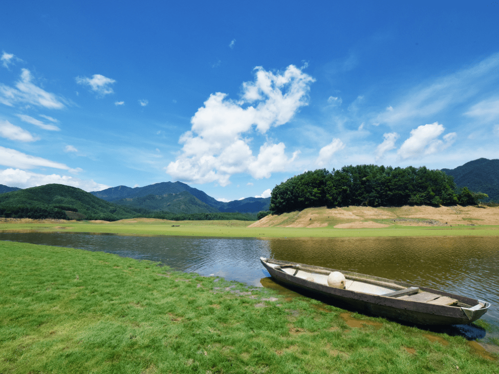 Serene view of Hoa Trung Lake surrounded by green hills.