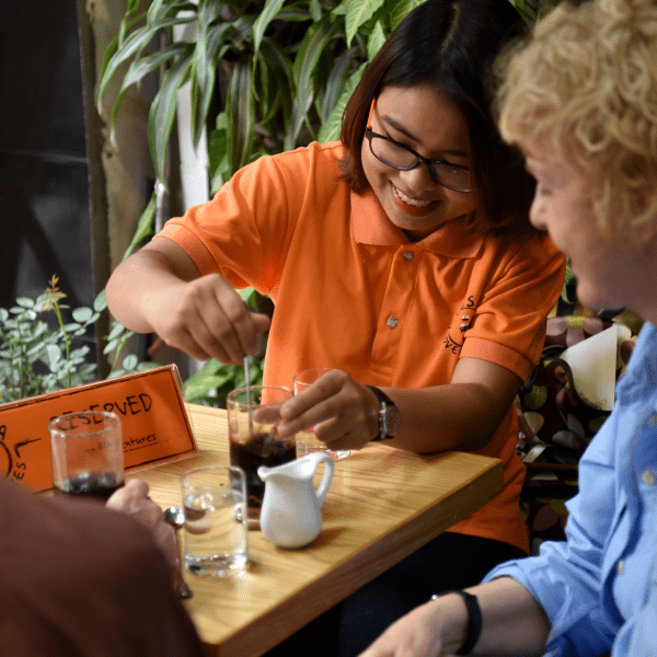 Hỏa Xa Cafe near the train tracks in Hanoi, where tourists relax after a Vespa tour.