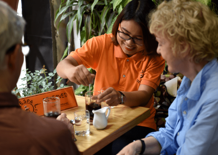 Hỏa Xa Cafe near the train tracks in Hanoi, where tourists relax after a Vespa tour.