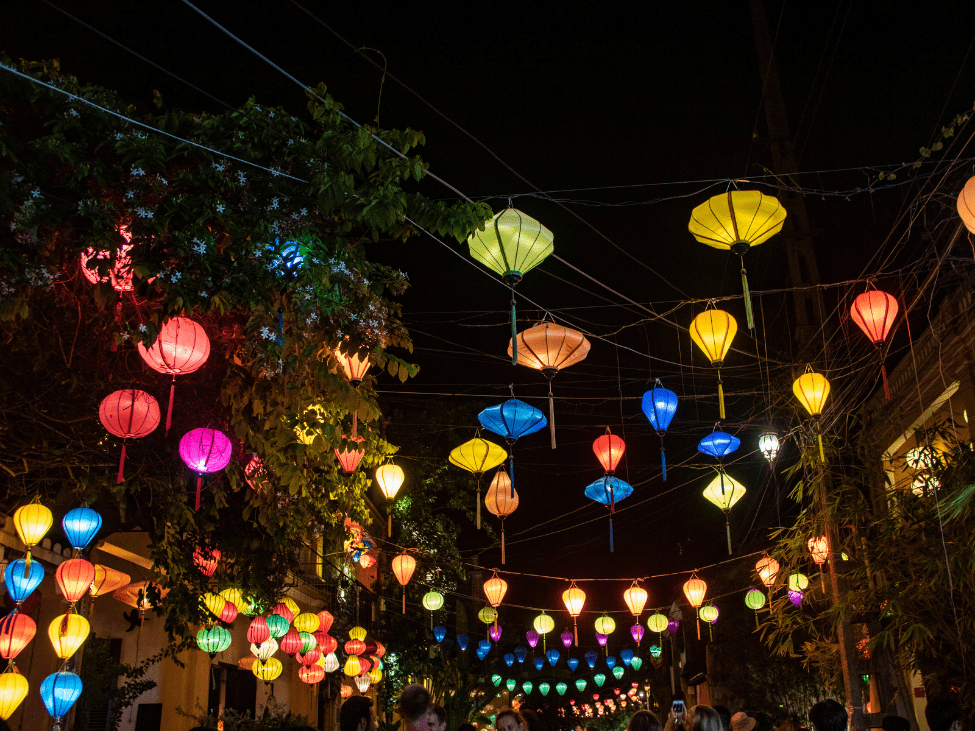 Lantern-lit street in Hoi An at night, capturing the enchanting atmosphere of the ancient town.