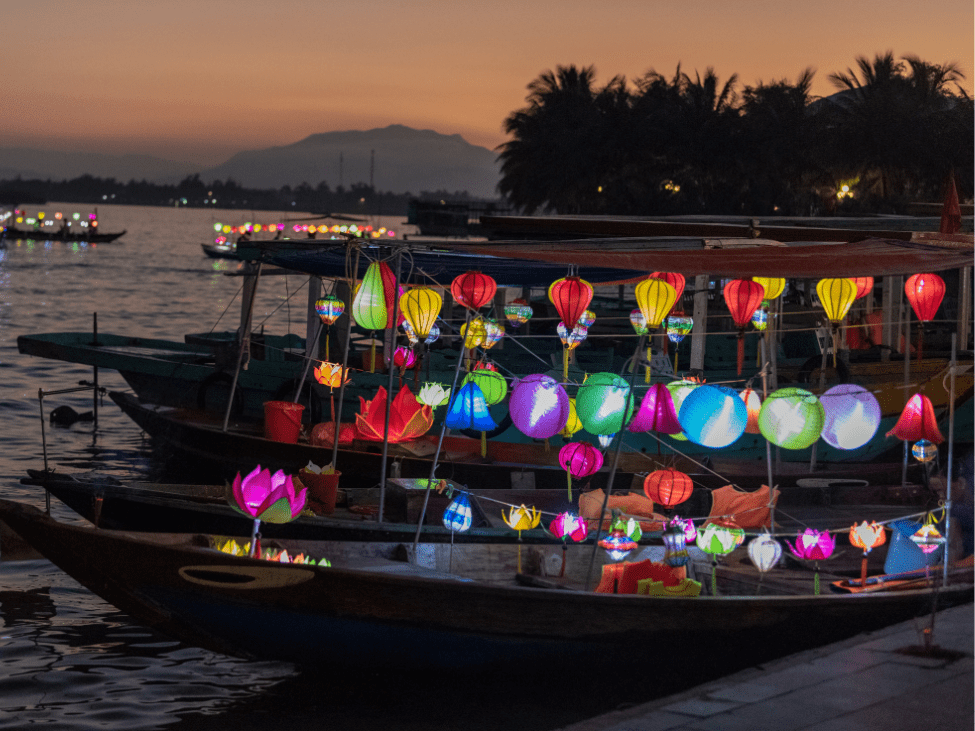 Lanterns reflecting on the tranquil waters of the Hoi An lantern river at night.