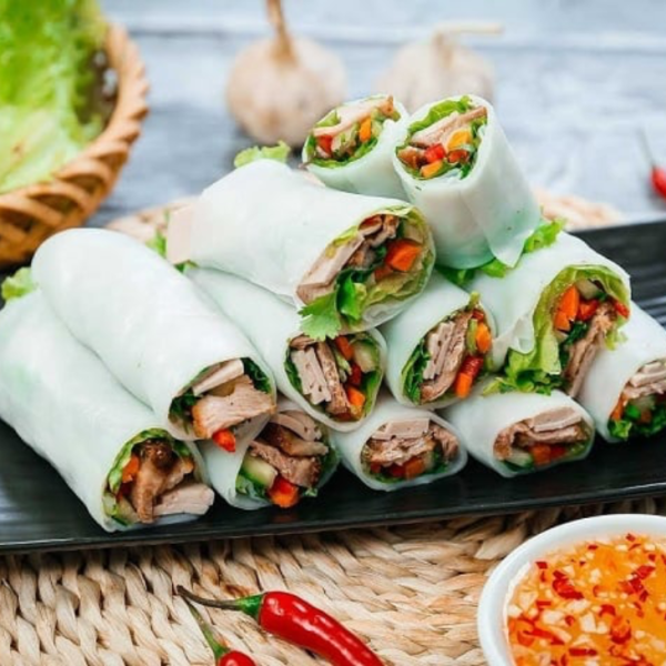 A plate of pho cuon from Hương Mai in Hanoi, featuring tender beef and fresh herbs