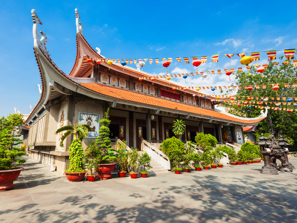 Interior of the Jade Emperor Pagoda in Ho Chi Minh City, with incense smoke and vibrant decorations.