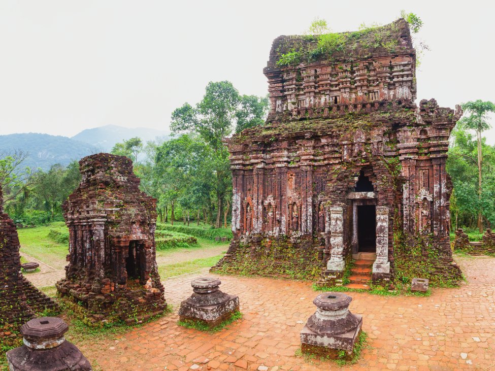 Ancient brick structures of the My Son Temples surrounded by jungle in Vietnam.