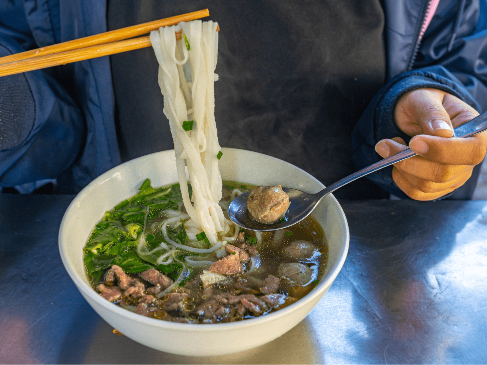 A flavorful bowl of pho in Saigon with bean sprouts and fresh herbs.