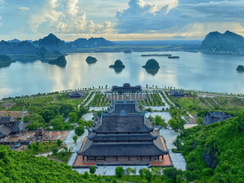 The vast Tam Chuc Pagoda complex, with pagodas set against a backdrop of mountains and water.