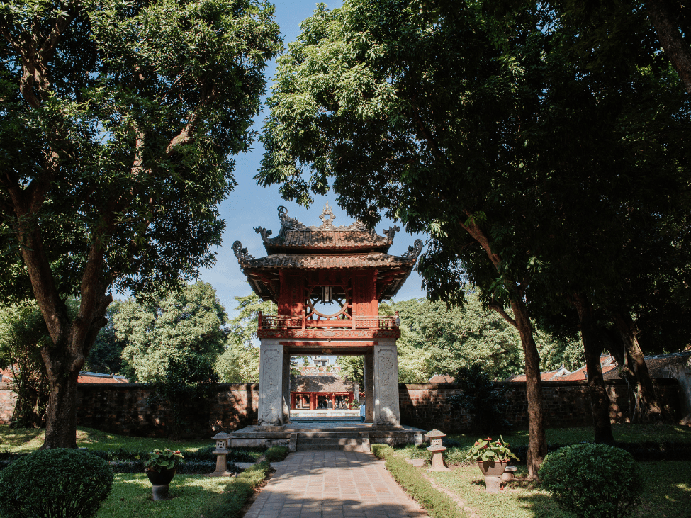 The historic Temple of Literature in Hanoi hosting special events and performances during the Mid-Autumn Festival, with traditional music and lion dances in the serene setting.