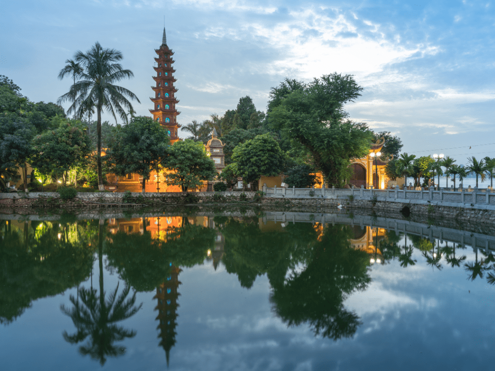 View of Tran Quoc Pagoda on West Lake, Hanoi, with its ancient tower and serene surroundings.