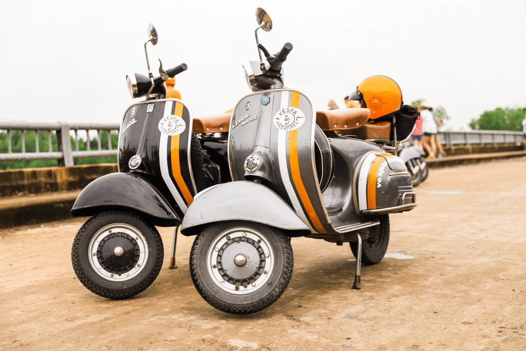 A couple riding a Vespa through scenic Vietnam streets, capturing the essence of adventure and romance.