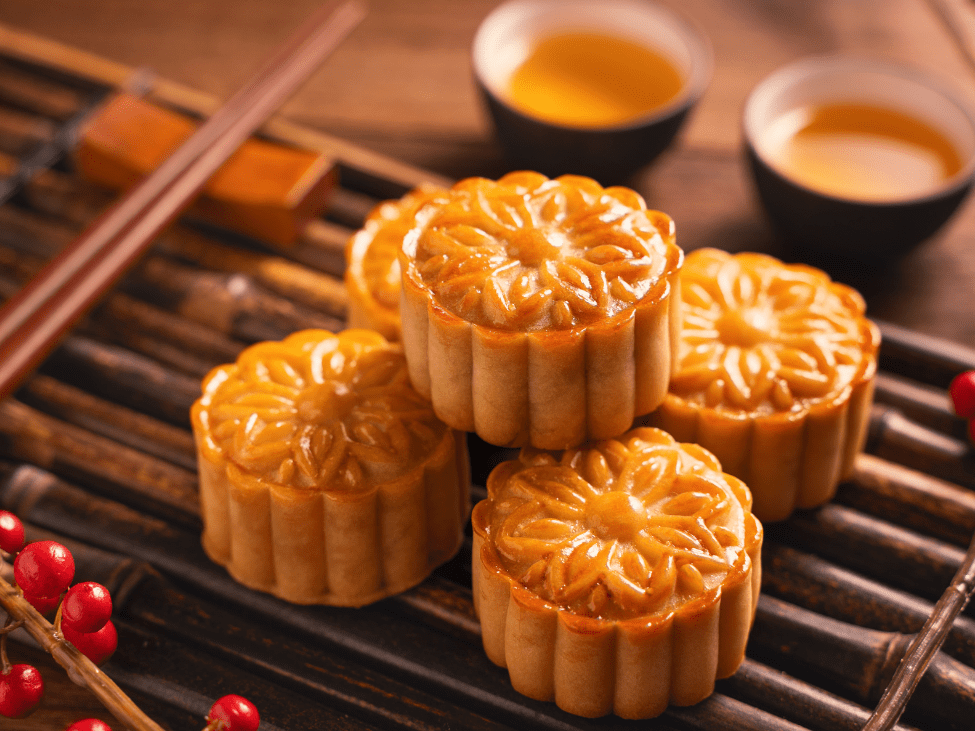 A variety of traditional Vietnamese mooncakes on display during the Mid-Autumn Festival, symbolizing unity and togetherness.