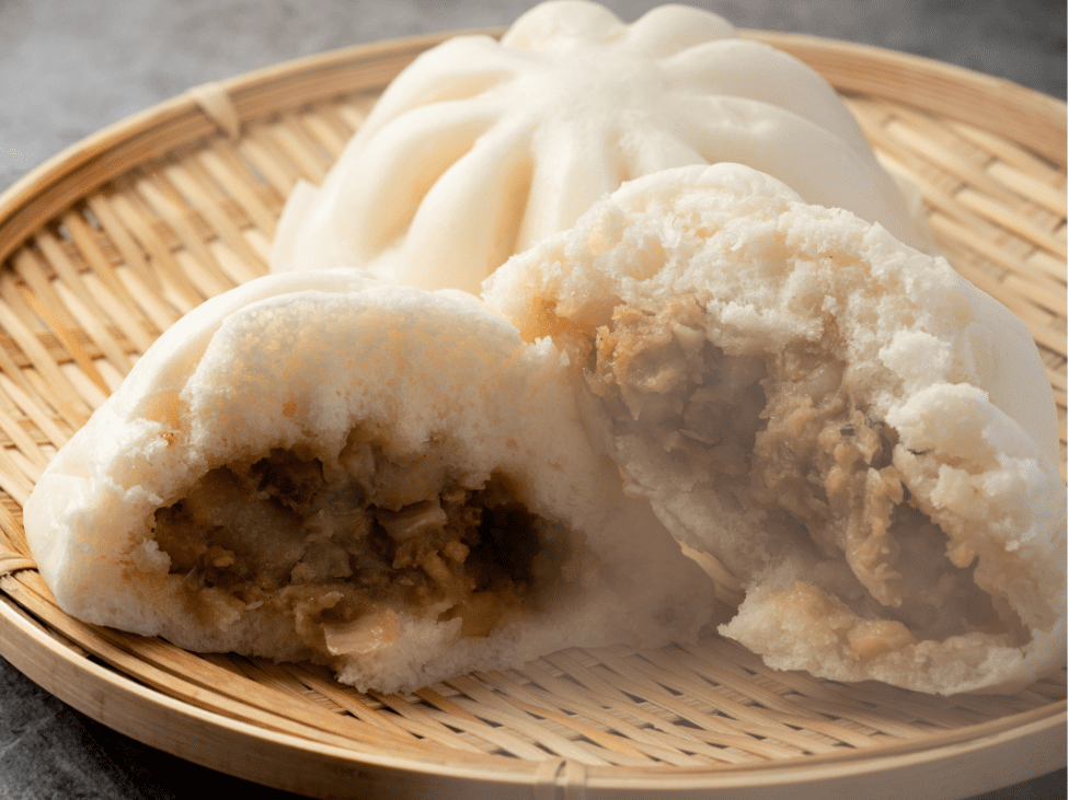 A freshly steamed Bánh Bao filled with pork and quail eggs.