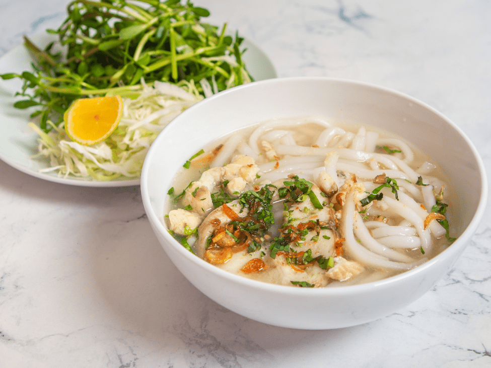 A hearty bowl of Banh Canh with thick noodles and shrimp.