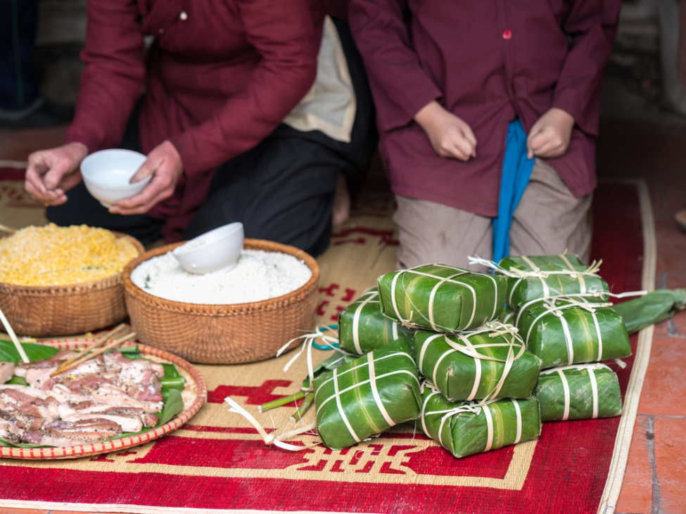 A traditional Vietnamese banh chung wrapped in green dong leaves