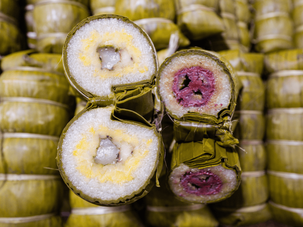 Banh tet chuoi with banana filling and purple-colored sticky rice