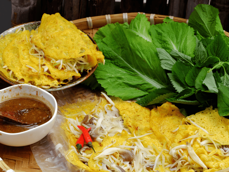 A crispy bánh xèo pancake filled with shrimp, pork, and bean sprouts.