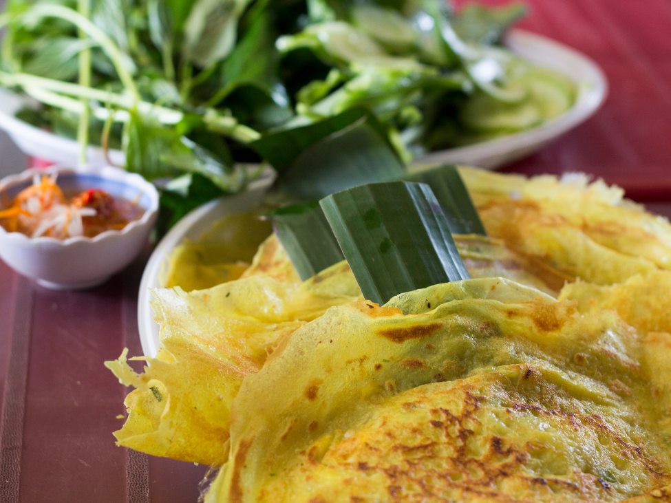 A crispy Vietnamese Bánh Xèo pancake filled with shrimp and pork.