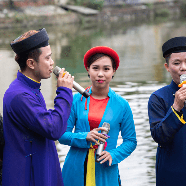 Musicians perform classical Vietnamese music using traditional instruments at a cultural concert.