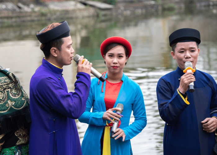 Musicians perform classical Vietnamese music using traditional instruments at a cultural concert.