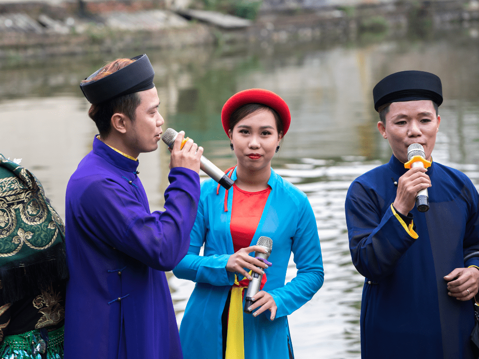 Musicians perform classical Vietnamese music using traditional instruments at a cultural concert.