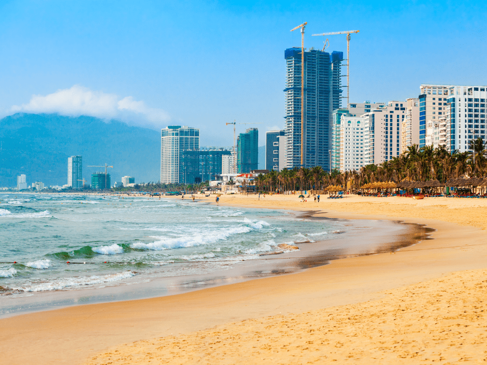 Panoramic view of My Khe Beach with clear blue waters and golden sands.