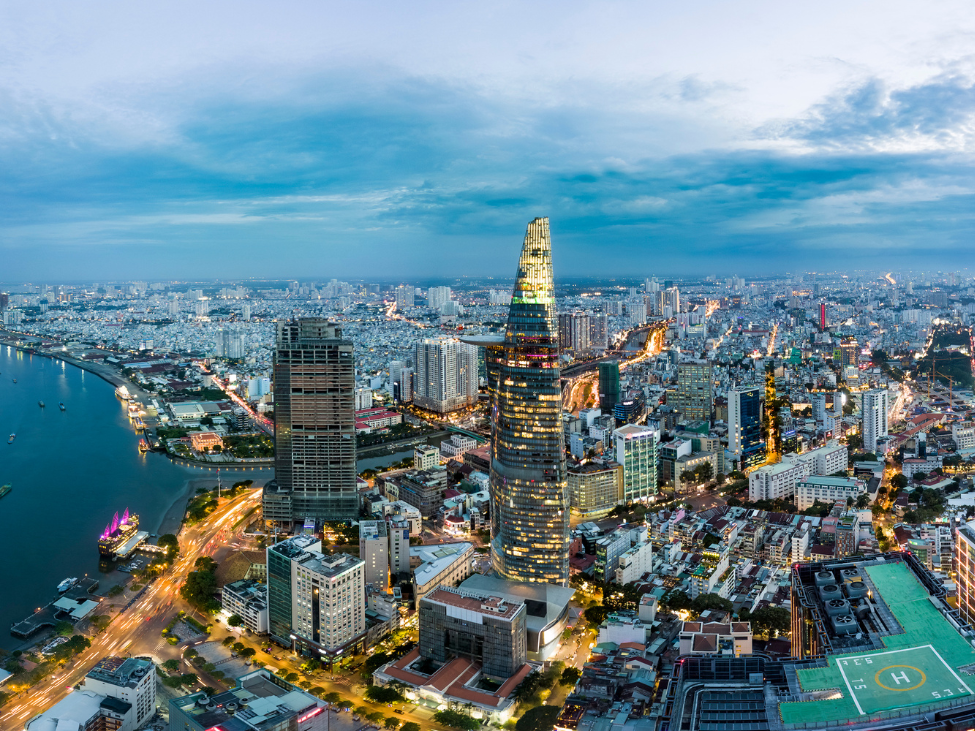 A panoramic view of Ho Chi Minh City’s bustling streets with motorbikes and skyscrapers.