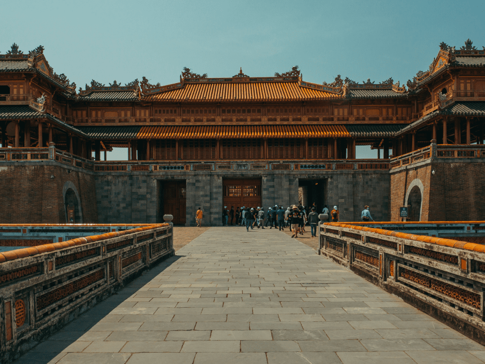 View of the Imperial Citadel in Hue with ancient structures and a tranquil moat.