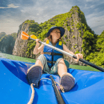 Kayakers exploring the limestone cliffs of Ha Long Bay.