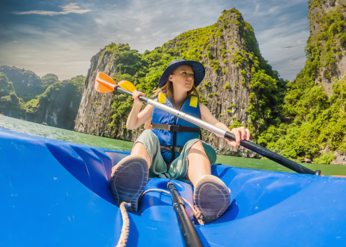 Kayakers exploring the limestone cliffs of Ha Long Bay.