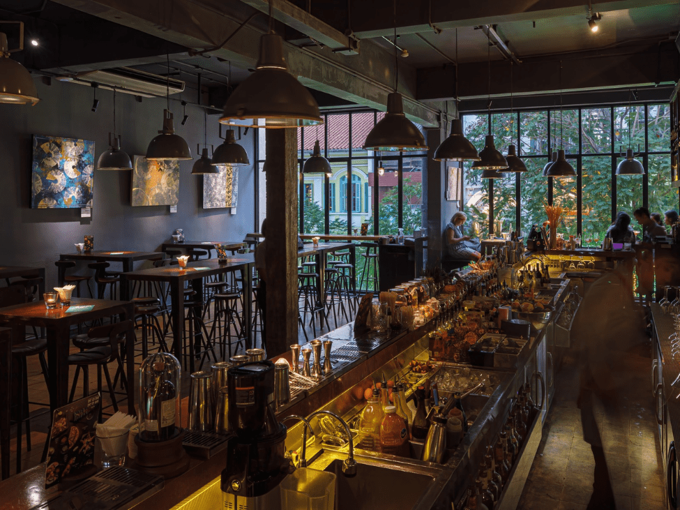 A cozy interior view of Layla Bar with guests enjoying cocktails in Ho Chi Minh City.