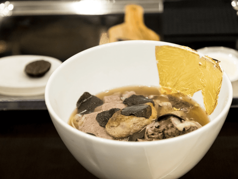 A bowl of “Phở King” at Landmark 81, featuring Wagyu beef, truffle shavings, foie gras, and gold leaf, served in an elegant setting.