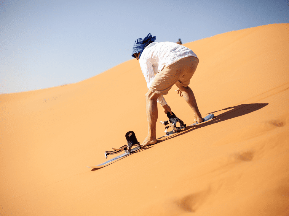 Family sandboarding on the dunes of Mui Ne.