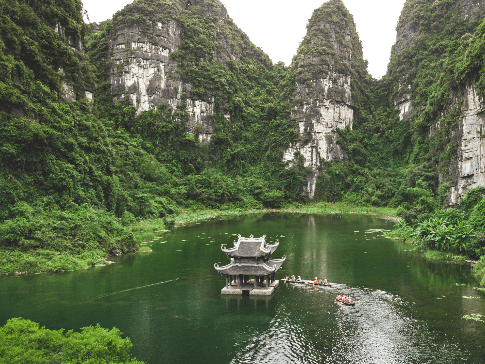 Tranquil waterways of Ninh Binh under July skies.