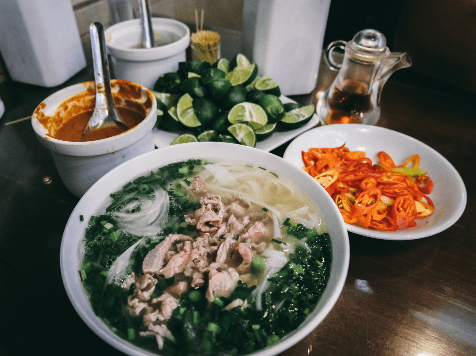 A tranquil scene inside Phở Gia Truyền Bảo Khánh, with customers enjoying their meals in a cozy setting.