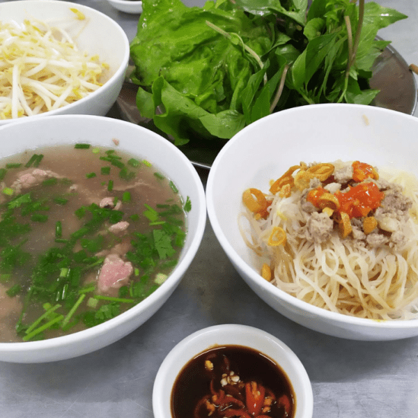 Two bowls of pho—one with noodles, the other with broth and beef meatballs.