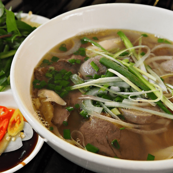 Pho Le's iconic bowl of pho with meatballs and a side of bean sprouts.