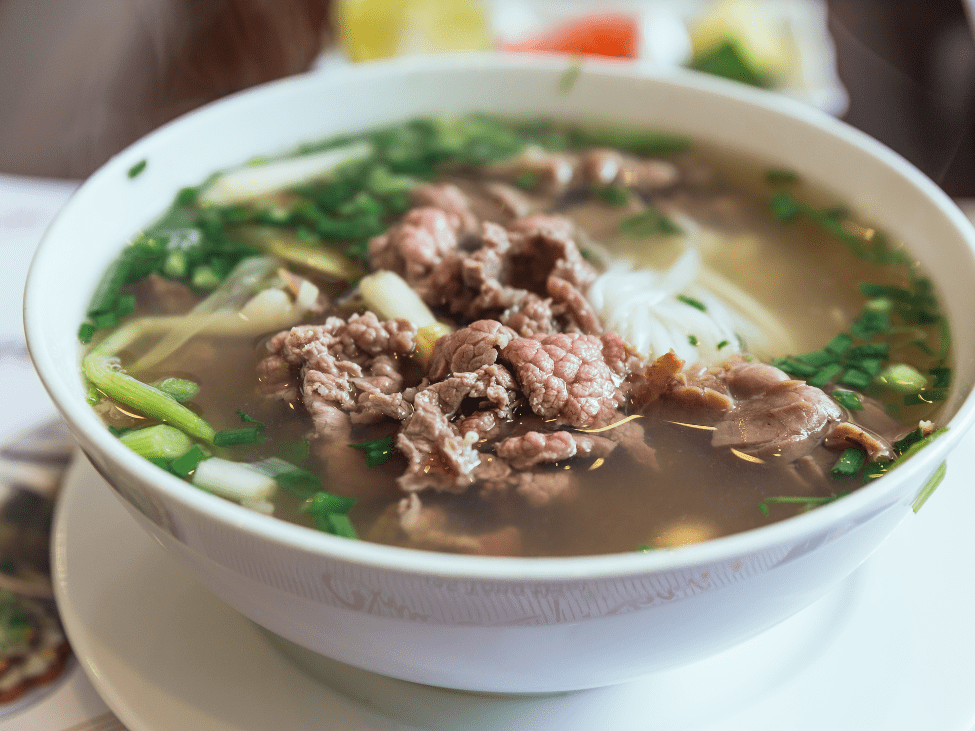 A bowl of Phở Mặn with brisket and tendon, known for its salty broth.