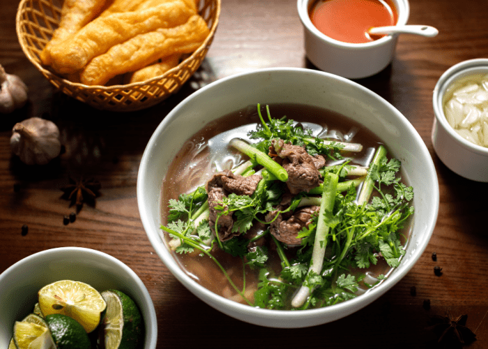 A bowl of Pho Bo from Pho Thin in Hanoi with thinly sliced beef and clear broth.