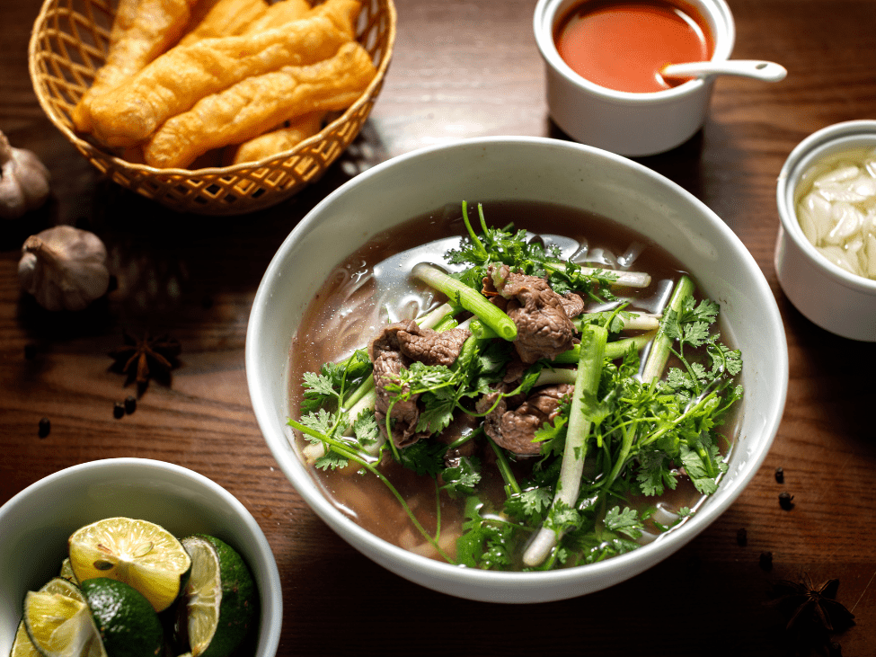 A bowl of Pho Bo from Pho Thin in Hanoi with thinly sliced beef and clear broth.