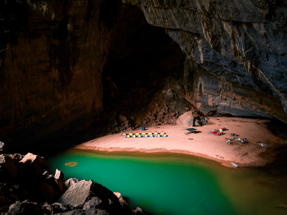 A boat navigating through the stunning interior of Phong Nha Cave.