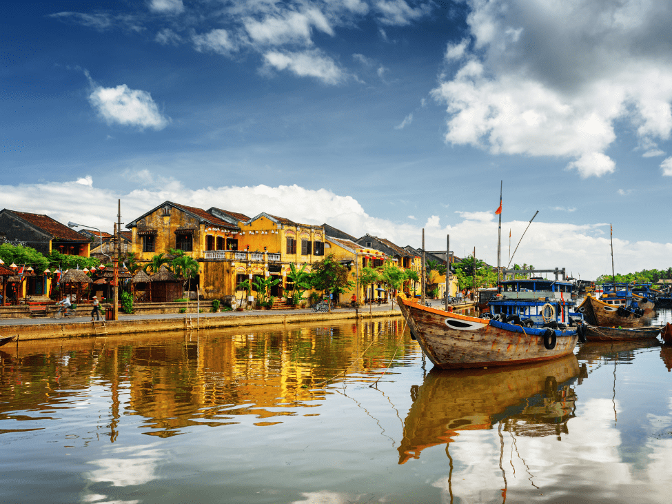 A panoramic view of the Thu Bon River from the new bridge, with Hoi An town in the distance.