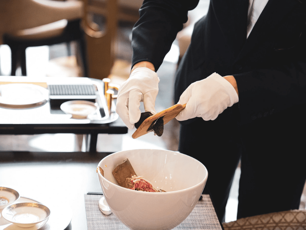 Waitstaff shaving fresh truffle onto the “Phở King” as part of the exclusive dining experience at Landmark 81.