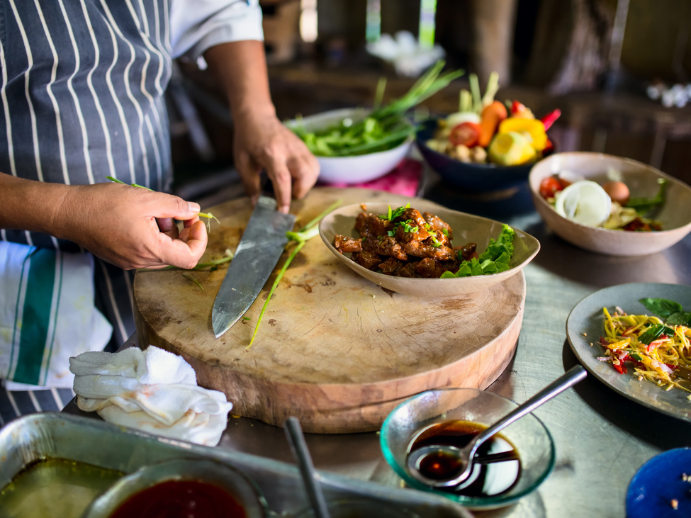 Family cooking traditional Vietnamese dishes in a cooking class.