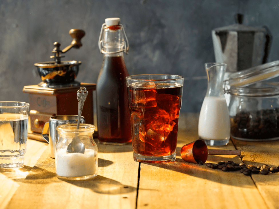 Vietnamese cold brew coffee in a glass bottle with a glass of ice.