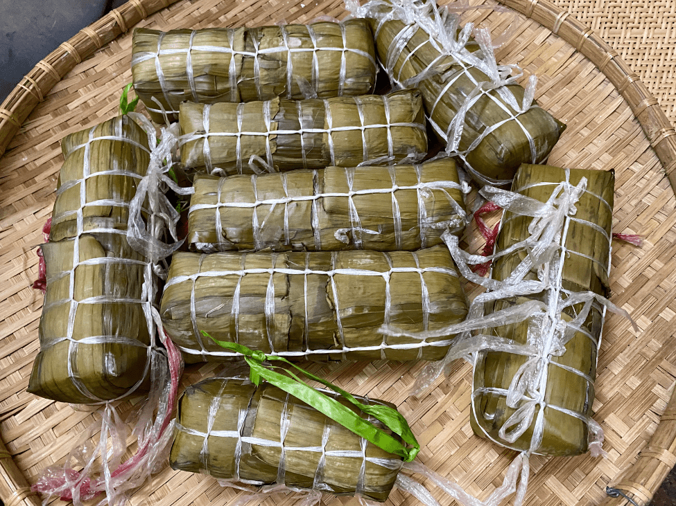 Traditional Vietnamese Banh Tet cake sliced and served on a festive platter.