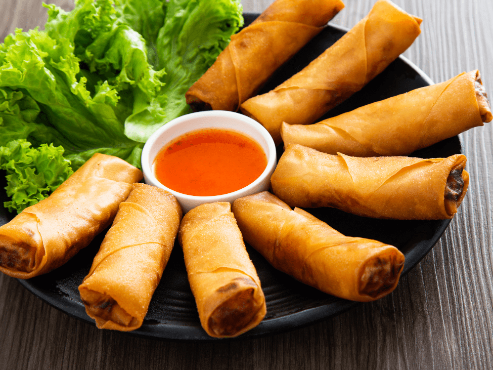 Vietnamese spring rolls served with dipping sauce.